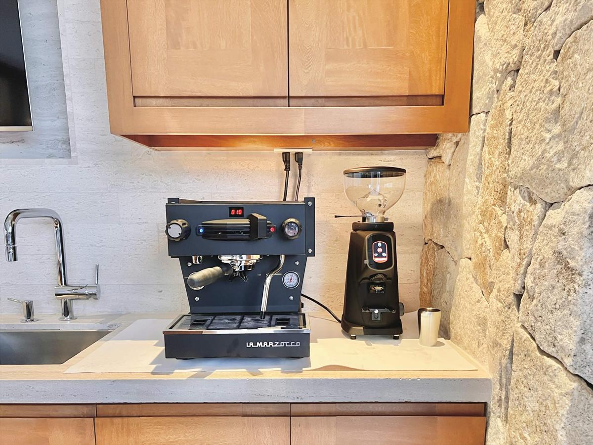 A La Marzocco Linea Mini and grinder set up on a home kitchen counter